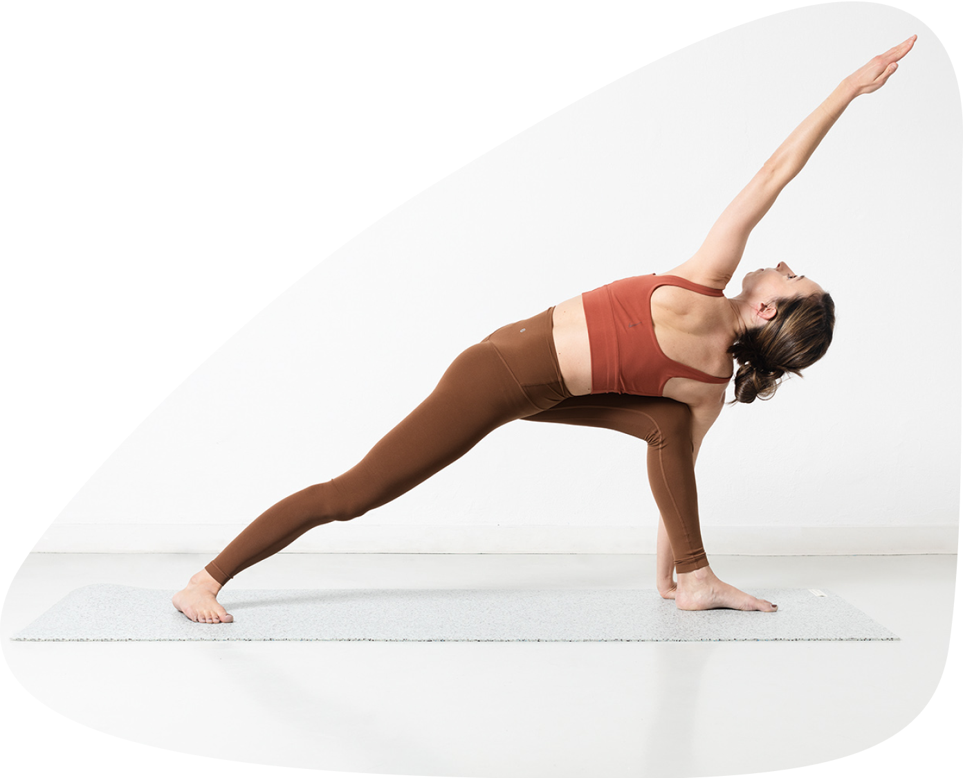 a woman is doing a yoga pose on a mat